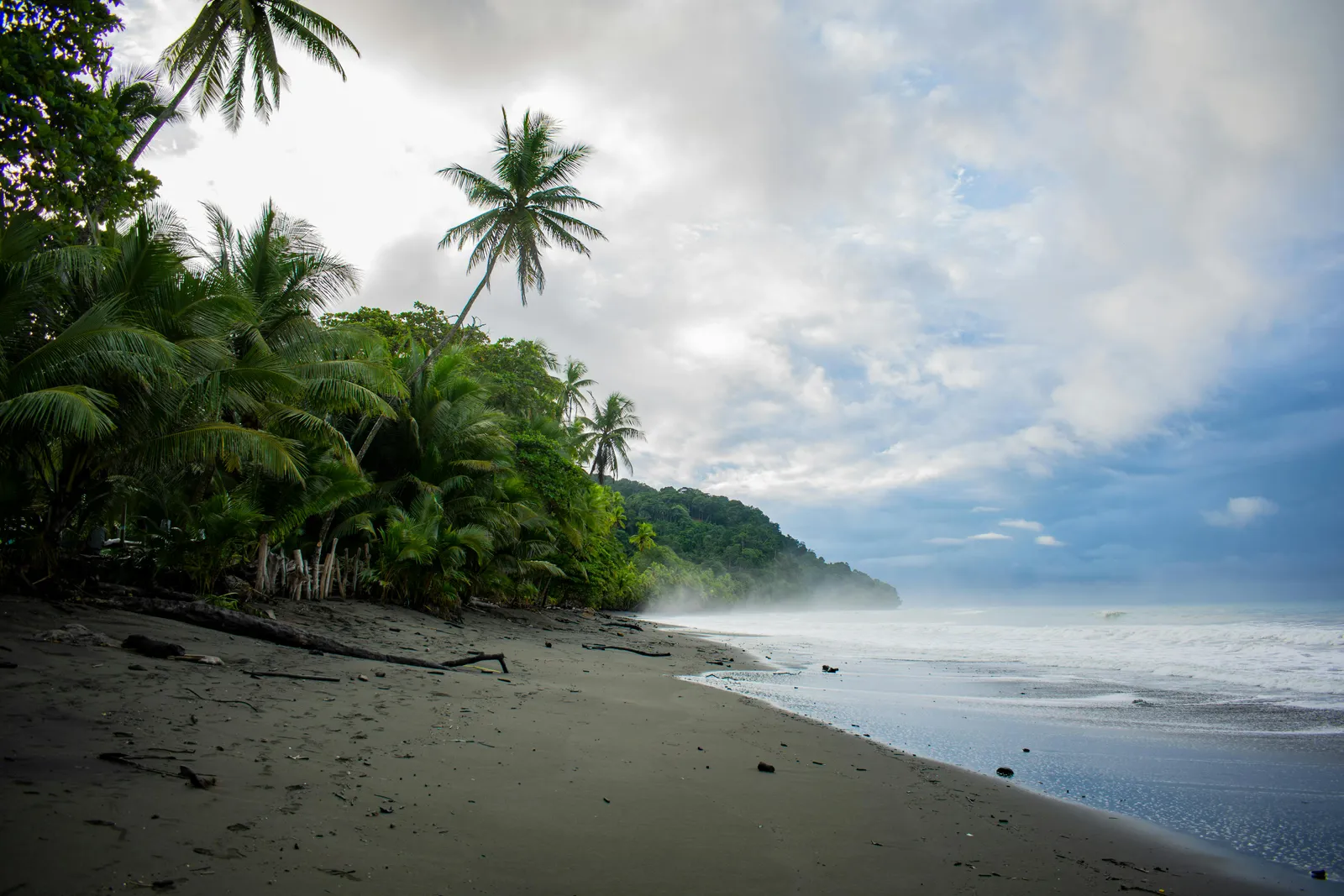 Pacific Costa Rica beach break at golden hour with a head-high right.